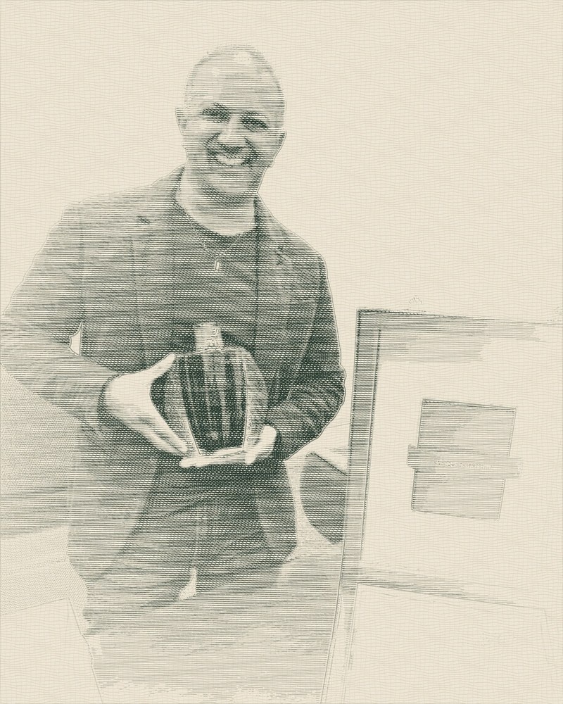 Darren Solanki, founder of Scotch Racer, holding a Macallan 50 Years Old in Lalique crystal beside its presentation case, drawn as a banknote-style engraving